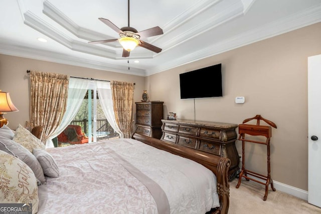 carpeted bedroom with a raised ceiling, a ceiling fan, crown molding, baseboards, and access to exterior