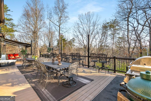 wooden deck featuring outdoor dining area