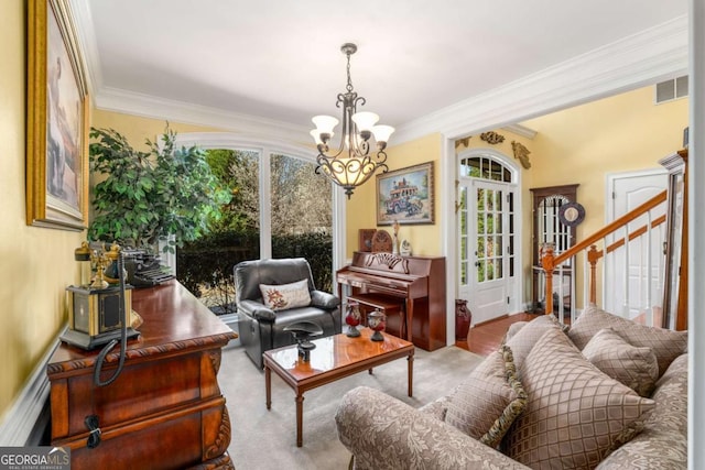 interior space with visible vents, a notable chandelier, ornamental molding, baseboards, and stairs