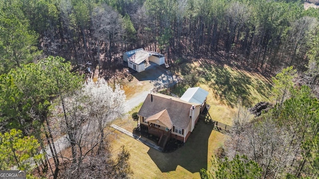 birds eye view of property with a wooded view