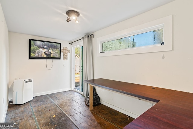 interior space with baseboards and hardwood / wood-style floors