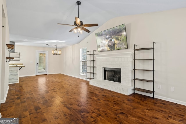 unfurnished living room with wood-type flooring, baseboards, a brick fireplace, ceiling fan, and vaulted ceiling