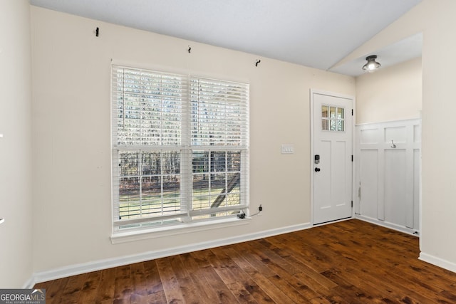 foyer featuring baseboards, lofted ceiling, and hardwood / wood-style flooring