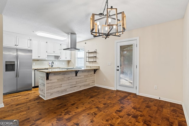 kitchen featuring stainless steel fridge with ice dispenser, a peninsula, island exhaust hood, white cabinetry, and a sink