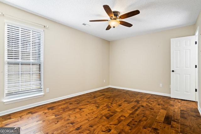 unfurnished room with hardwood / wood-style floors, a healthy amount of sunlight, and baseboards