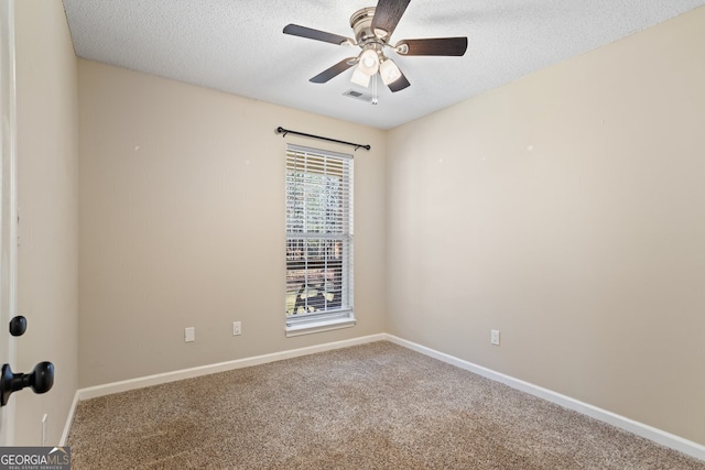 carpeted empty room featuring visible vents, baseboards, a textured ceiling, and ceiling fan