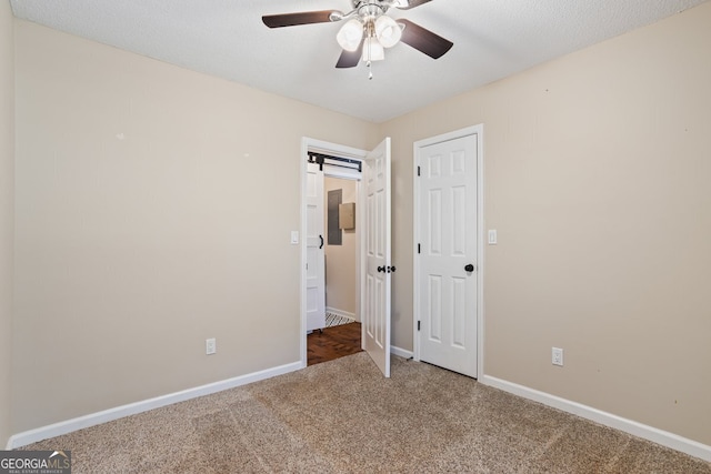 unfurnished bedroom featuring a ceiling fan, baseboards, and carpet floors