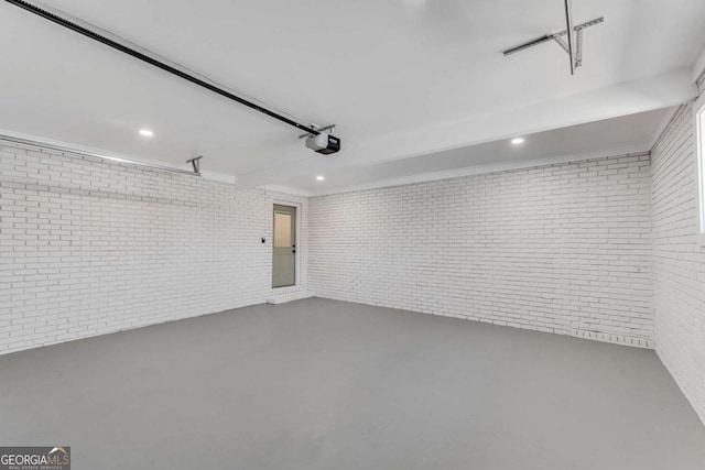 garage with recessed lighting and a garage door opener