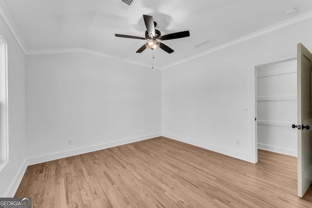 unfurnished room featuring visible vents, crown molding, baseboards, light wood-style floors, and a ceiling fan