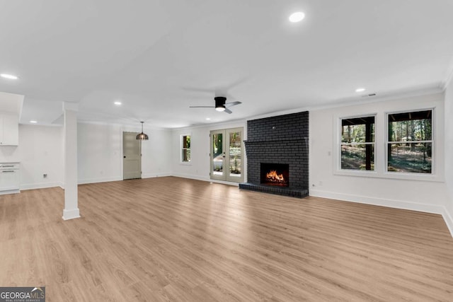 unfurnished living room featuring baseboards, recessed lighting, a fireplace, ceiling fan, and light wood-style floors