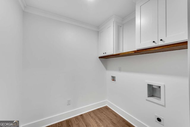 washroom featuring washer hookup, wood finished floors, cabinet space, baseboards, and hookup for an electric dryer