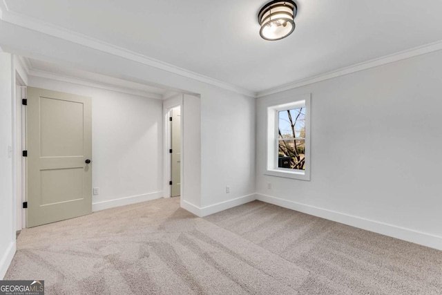 spare room featuring baseboards, carpet, and ornamental molding