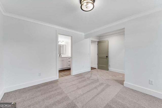 unfurnished bedroom featuring baseboards, crown molding, and carpet