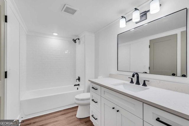 bathroom with vanity, wood finished floors, visible vents, bathing tub / shower combination, and toilet