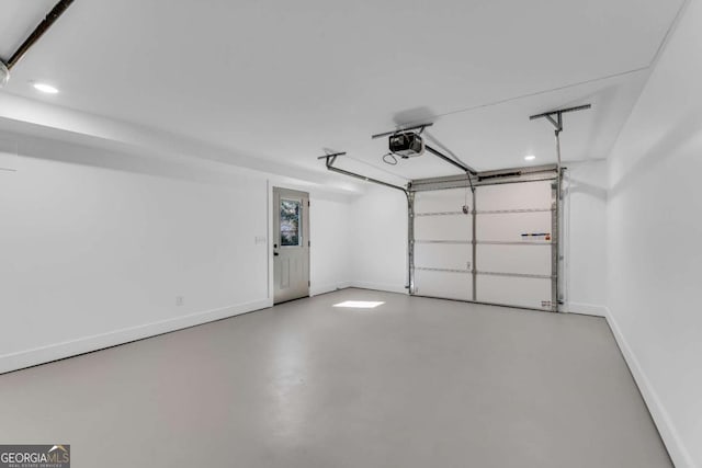 garage featuring a garage door opener and baseboards