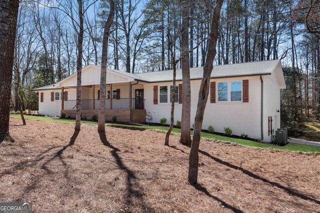 view of front of house with covered porch and brick siding