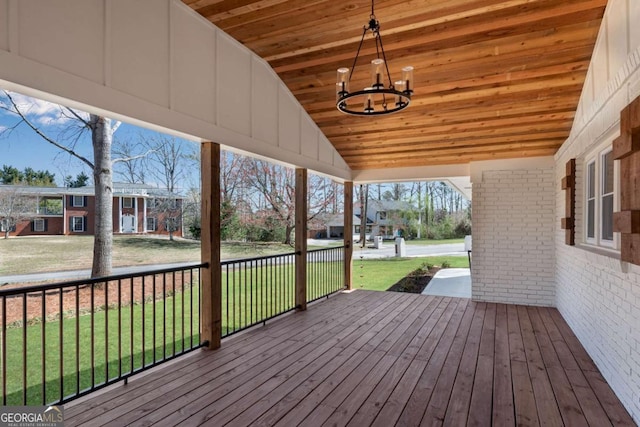 wooden deck featuring a lawn