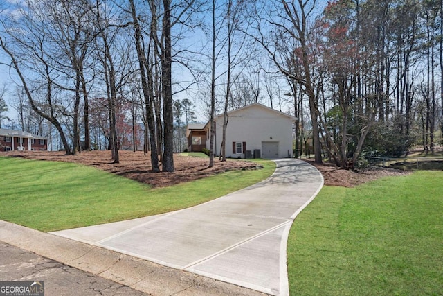 view of front of home with a garage and a front lawn