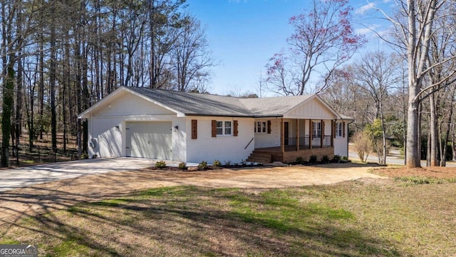 ranch-style house with a front lawn, an attached garage, brick siding, and driveway