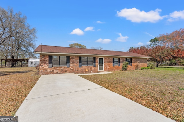 single story home with brick siding and a front yard