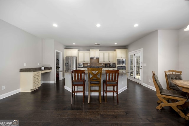 dining room featuring recessed lighting, baseboards, and dark wood finished floors