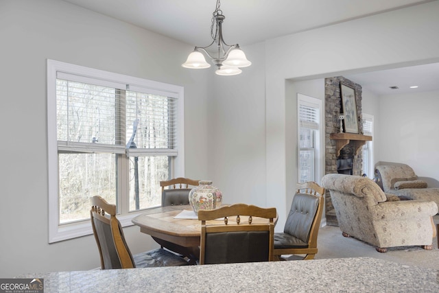 dining space featuring a chandelier and carpet