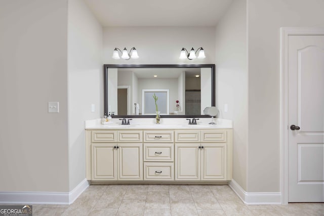 full bath featuring a sink, baseboards, and tile patterned floors