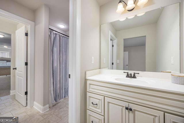 bathroom featuring a chandelier, vanity, and tile patterned flooring