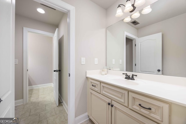 bathroom featuring visible vents, baseboards, vanity, and tile patterned flooring