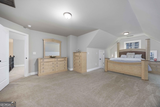 bedroom with visible vents, baseboards, carpet flooring, and vaulted ceiling