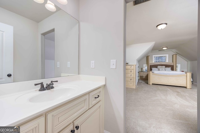 bathroom with vanity and lofted ceiling