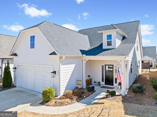 view of front of home with a porch, a garage, driveway, and roof with shingles