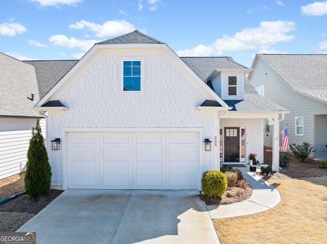 modern farmhouse style home with an attached garage, driveway, and a shingled roof