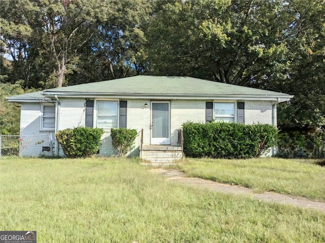 view of front of property with brick siding and a front yard