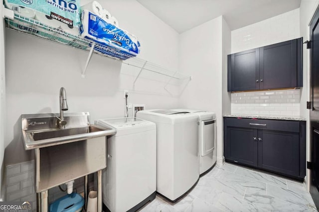 clothes washing area featuring cabinet space, marble finish floor, washer and dryer, and a sink