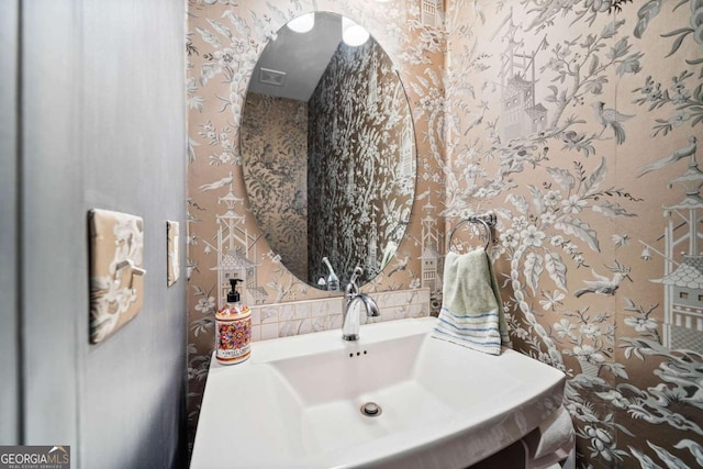 bathroom featuring wallpapered walls and vanity