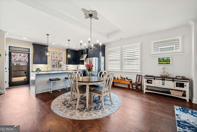 dining space featuring recessed lighting, a tray ceiling, dark wood finished floors, and crown molding