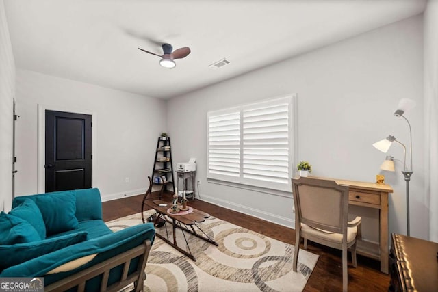 sitting room with visible vents, a ceiling fan, baseboards, and wood finished floors