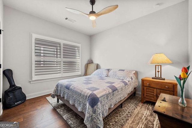 bedroom with visible vents, ceiling fan, baseboards, and wood finished floors