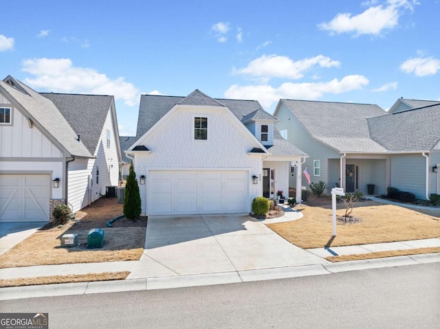 view of front of house with a garage, board and batten siding, concrete driveway, and a shingled roof