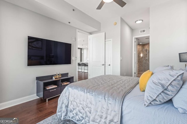 bedroom with baseboards, visible vents, dark wood finished floors, ceiling fan, and ensuite bathroom