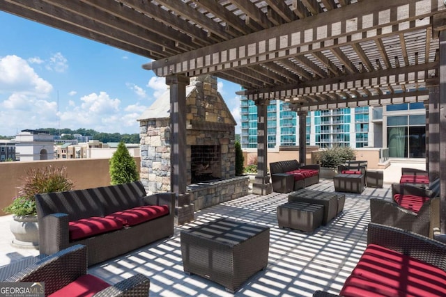 view of patio / terrace with an outdoor living space with a fireplace and a pergola