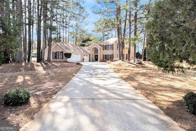 11 Tallulah Ct, Jonesboro, GA 30236 - colonial-style house featuring an attached garage, driveway, and brick siding
