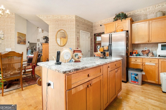 11 Tallulah Ct, Jonesboro, GA 30236 - kitchen featuring stainless steel fridge, light wood-style floors, a center island, backsplash, and wallpapered walls