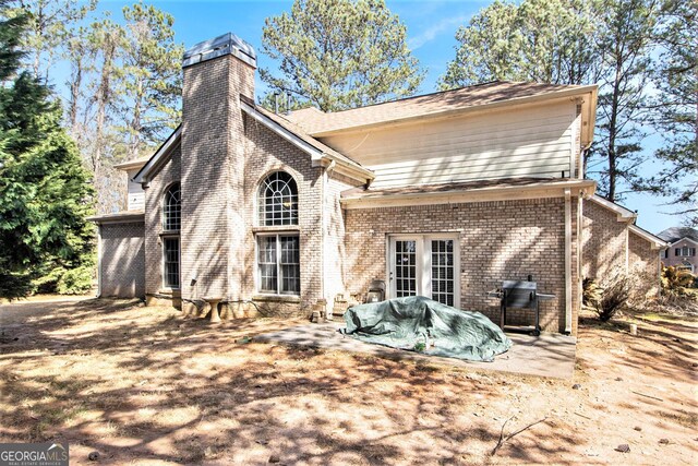 11 Tallulah Ct, Jonesboro, GA 30236 - back of property with brick siding and a chimney