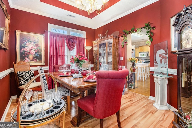 11 Tallulah Ct, Jonesboro, GA 30236 - dining room featuring a chandelier, wood finished floors, and crown molding
