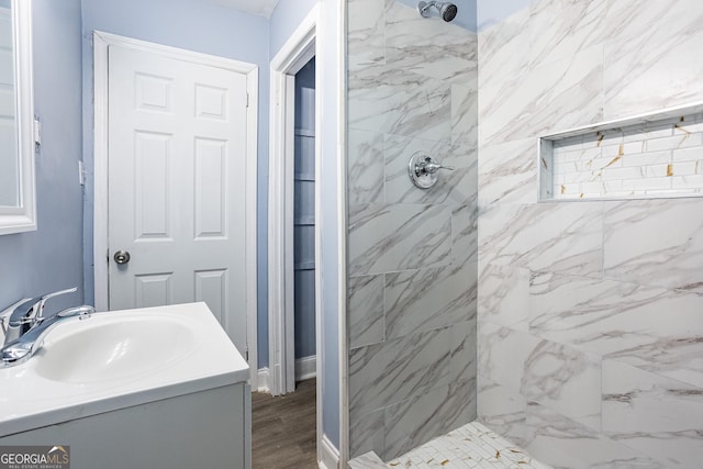 bathroom with vanity and tiled shower