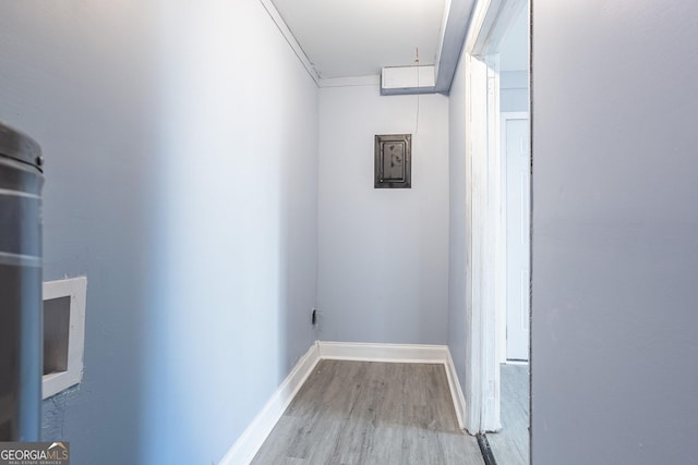 hall featuring baseboards and wood finished floors