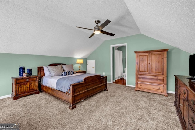 bedroom featuring baseboards, lofted ceiling, light colored carpet, and a textured ceiling