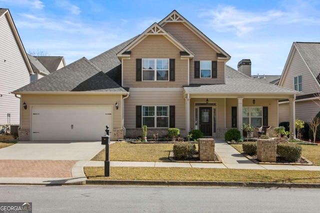 craftsman-style home with driveway, covered porch, an attached garage, a shingled roof, and a chimney